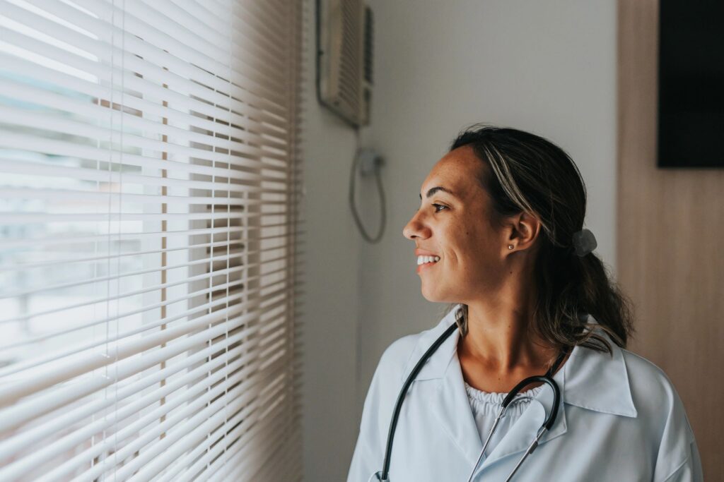 Friendly female doctor at the hospital window